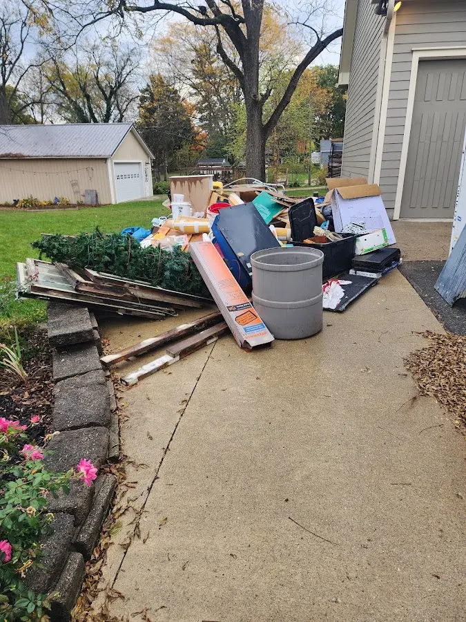 Dumpster being loaded with debris for 12 Yard Dumpster Rental in Chipley